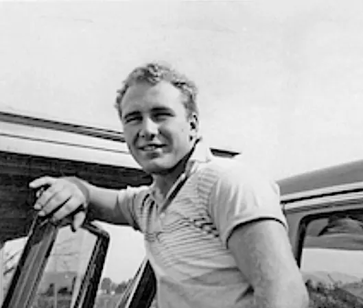 Young Kesey leaning on car copy